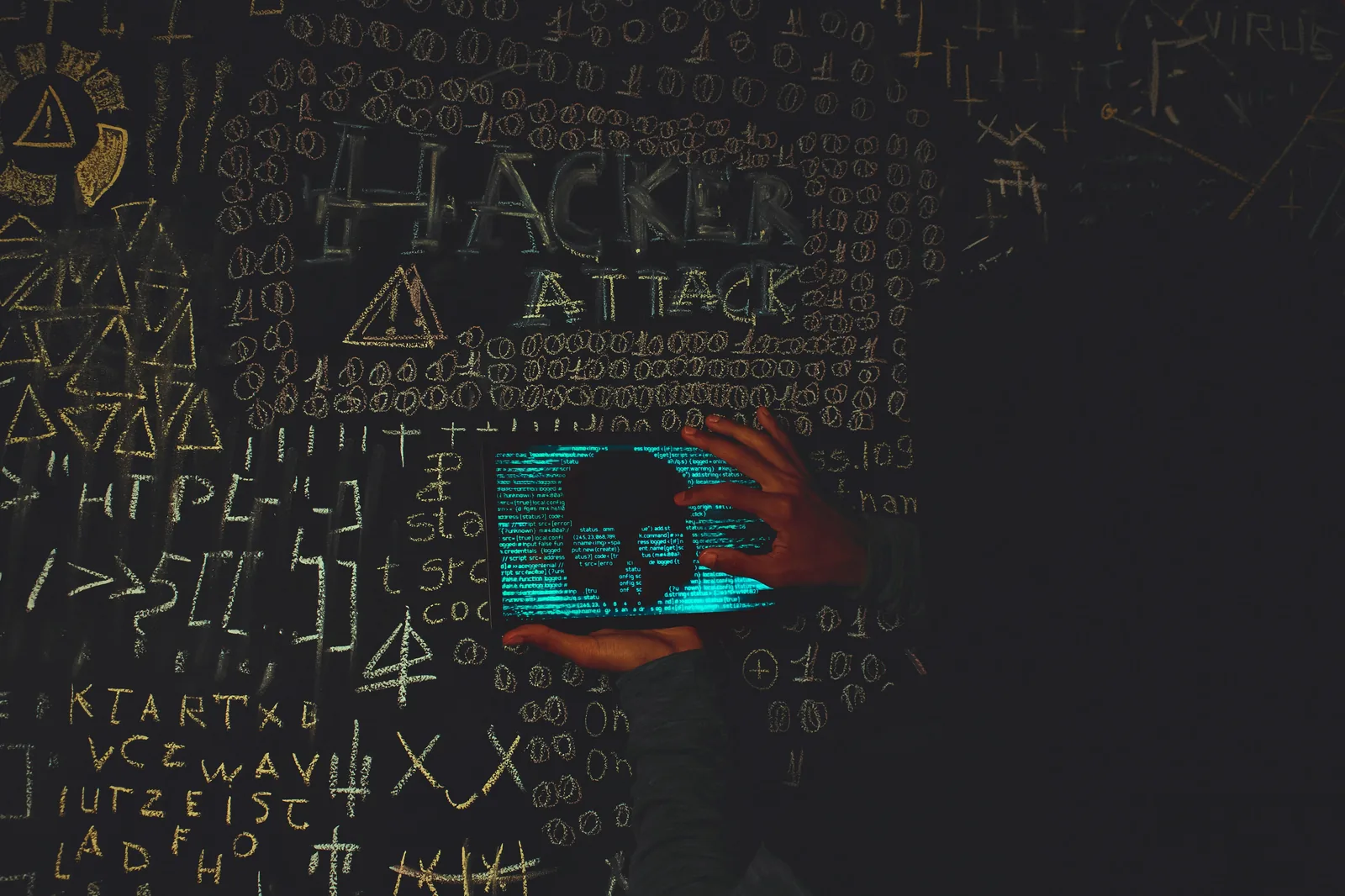Hand reaching toward laptop code with hacker attack text representing the AI security response gap