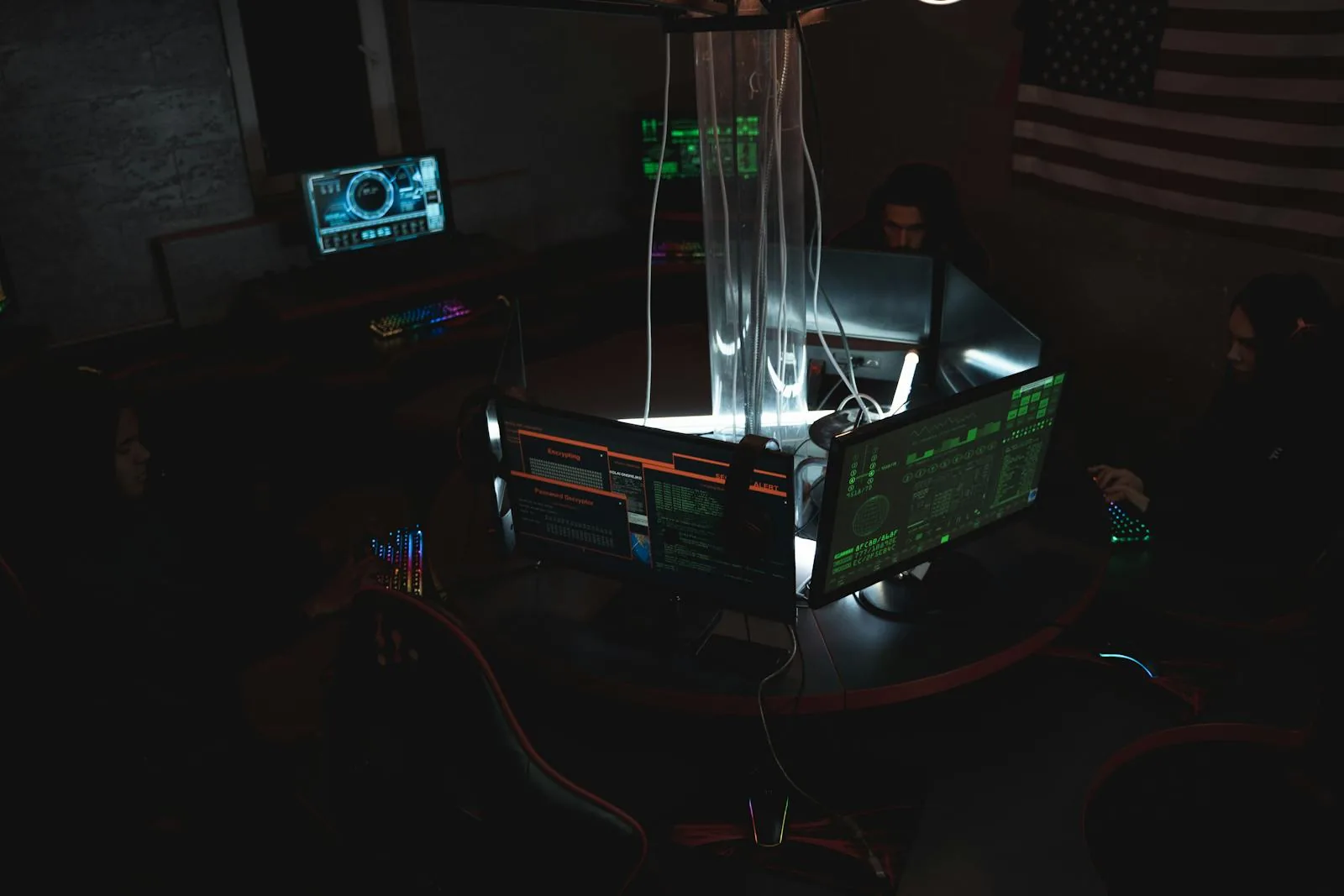 Cybersecurity team working at multiple monitors in professional AI security training lab for SANS and executive programs