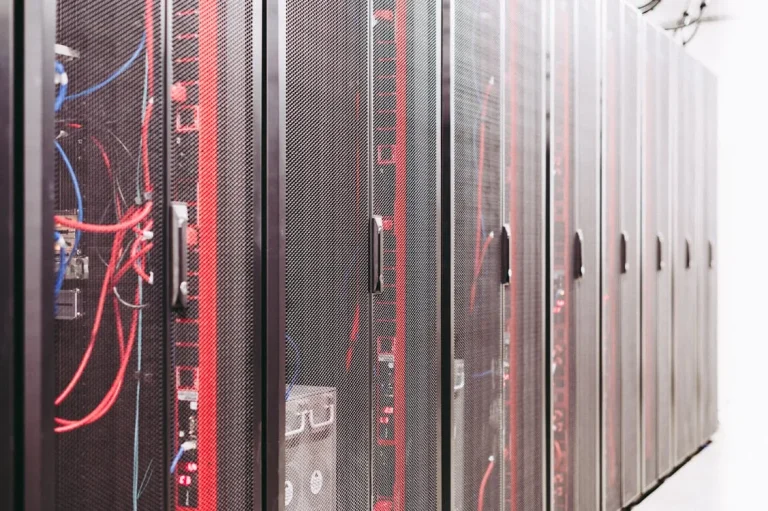 Server racks with network cables representing AI-powered information security infrastructure and identity management