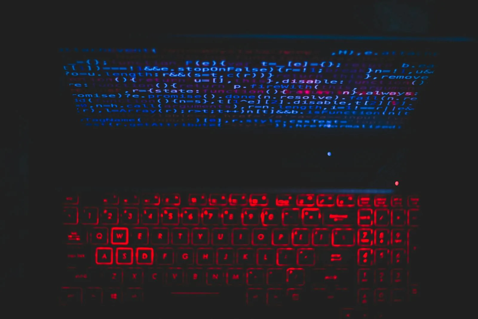 Dark laptop with red keyboard displaying security code representing AI security best practices and frameworks