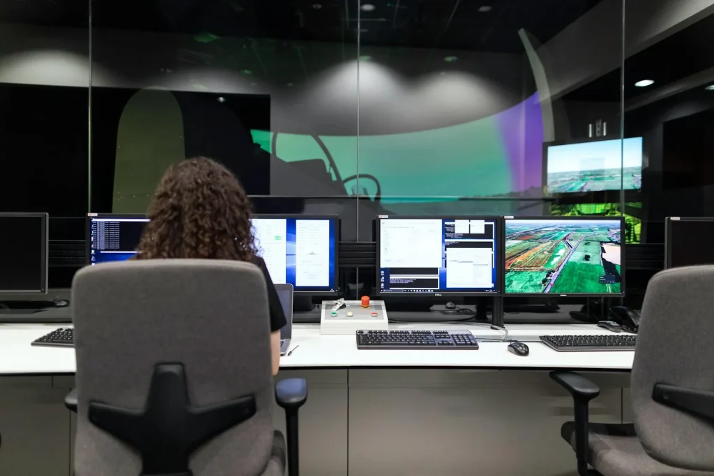 Security analyst monitoring AI threat intelligence on multiple screens in operations center
