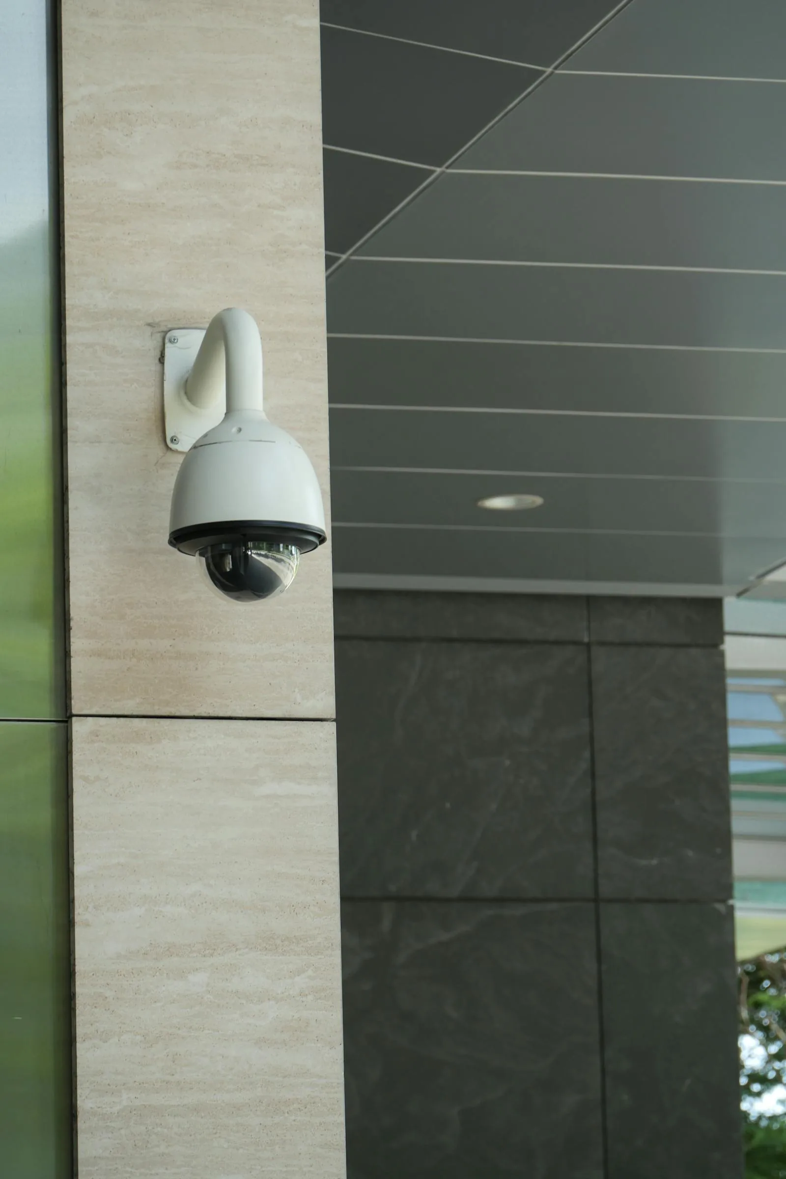 AI-powered dome surveillance camera mounted on school building exterior wall for physical security monitoring