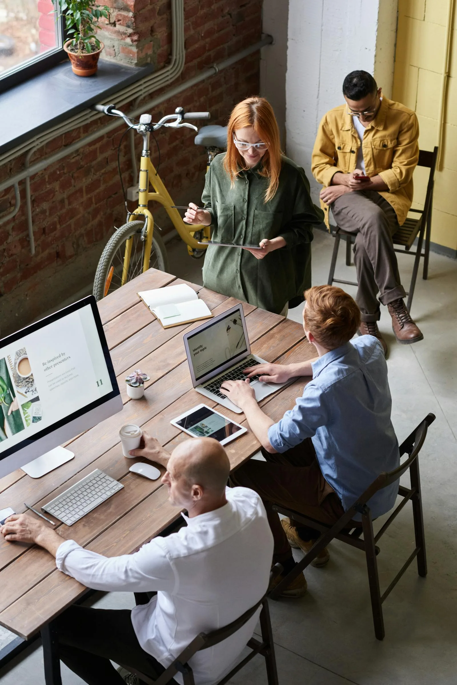 Tech team collaborating on AI security system implementation with multiple devices