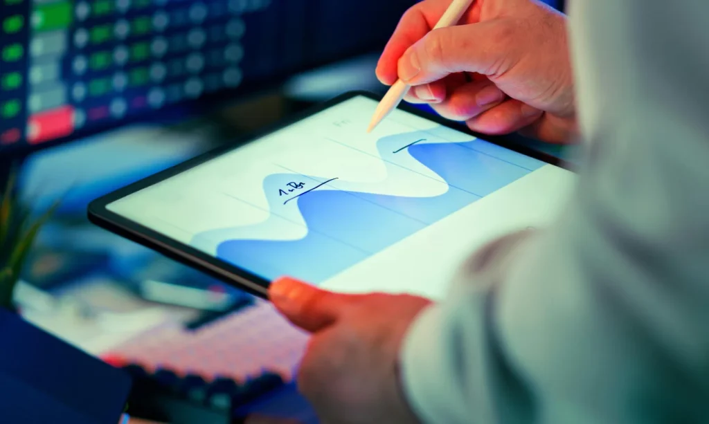 Intelligence analyst reviewing security assessment data using tablet and stylus for threat analysis