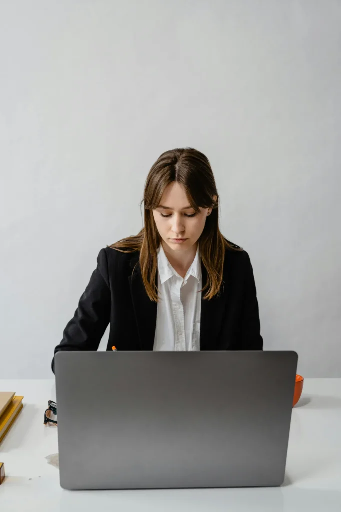 University student studying intelligence and cyber security BSc degree programs at laptop in bright modern professional setting representing BSc intelligence and cyber security studies
