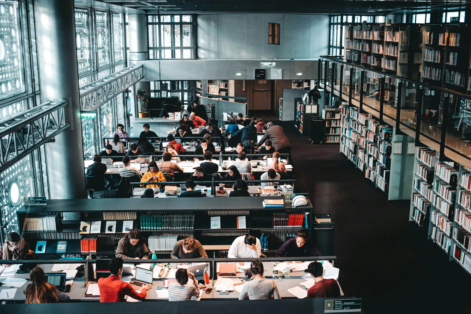 Students studying intelligence and cyber security BSc programs in bright university library representing BSc intelligence and cyber security studies programs UK US NCSC certified