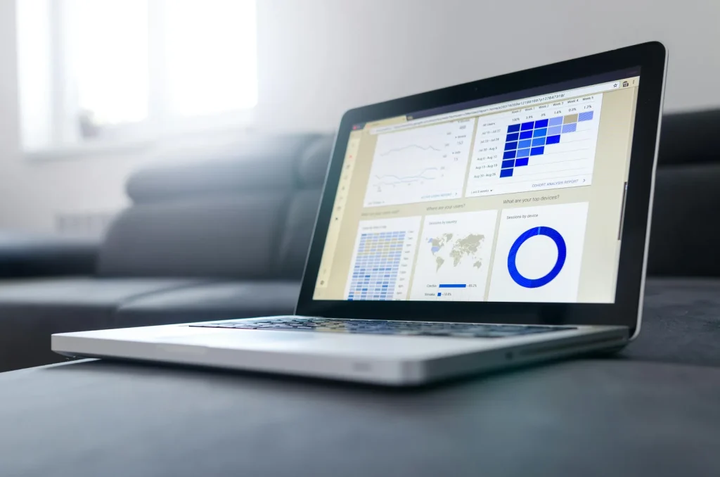 Security analyst reviewing business intelligence dashboard on computer screen in bright modern office representing business intelligence and cyber security