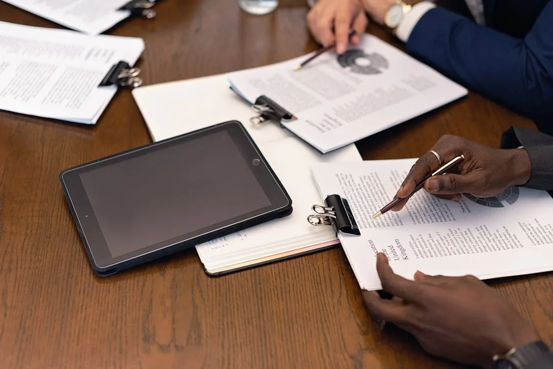 Enterprise security executive reviewing corporate security intelligence platform options on tablet in bright boardroom representing corporate security intelligence platforms Flashpoint Recorded Future enterprise integration