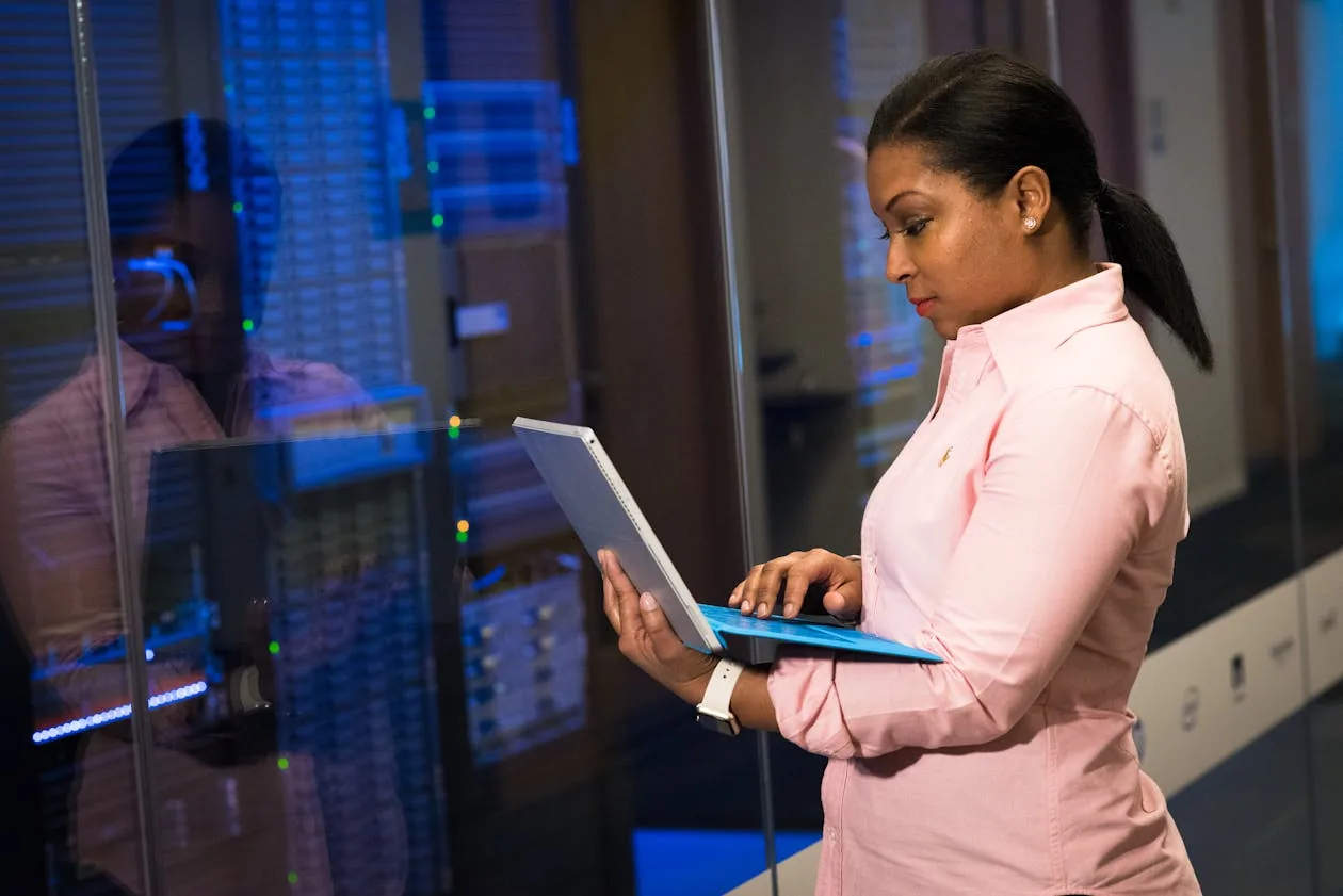 Security analyst with laptop in server room evaluating platform selection criteria
