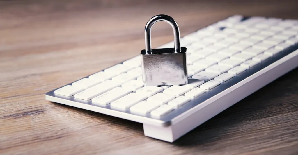 Silver padlock on white keyboard illustrating cyber security intelligence services and protection