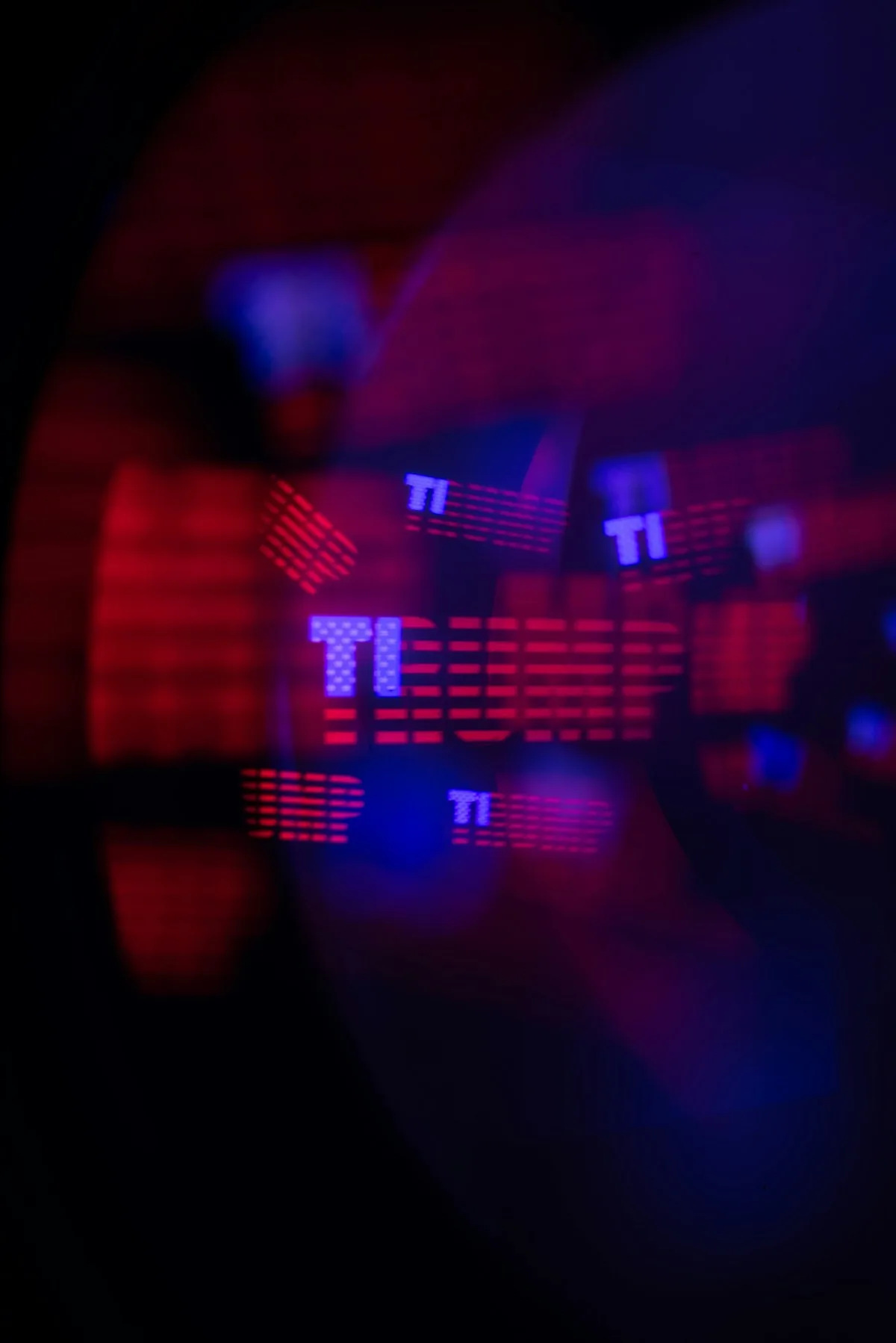 Abstract red and blue TI lights representing the three types of cyber threat intelligence: tactical, operational, and strategic