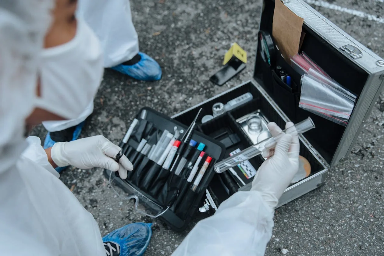 Forensic investigator with evidence collection kit representing digital forensics investigation process