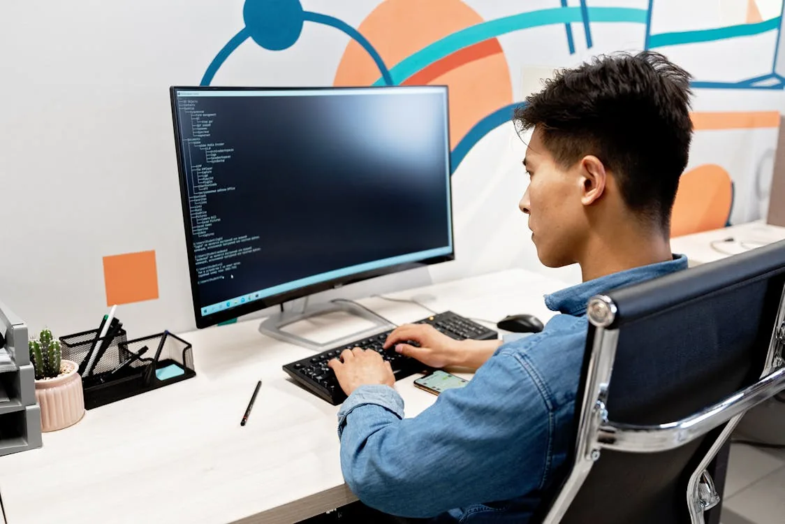 Programmer working on code comparing cyber security versus AI career paths