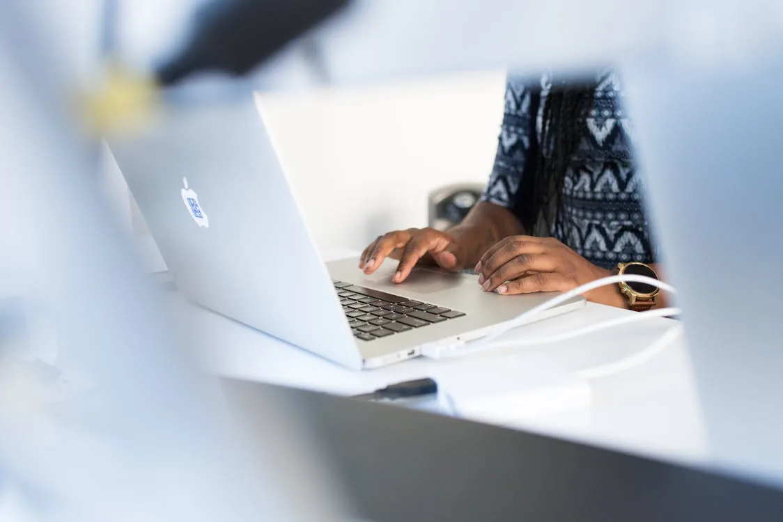 IT security professional reviewing domain intelligence platform dashboard on laptop in bright modern office representing domain security intelligence platforms DomainTools Cisco Umbrella enterprise integration