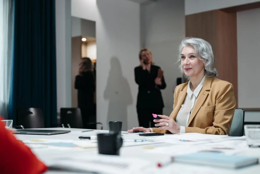Senior executive businesswoman in bright conference room representing executive security intelligence program