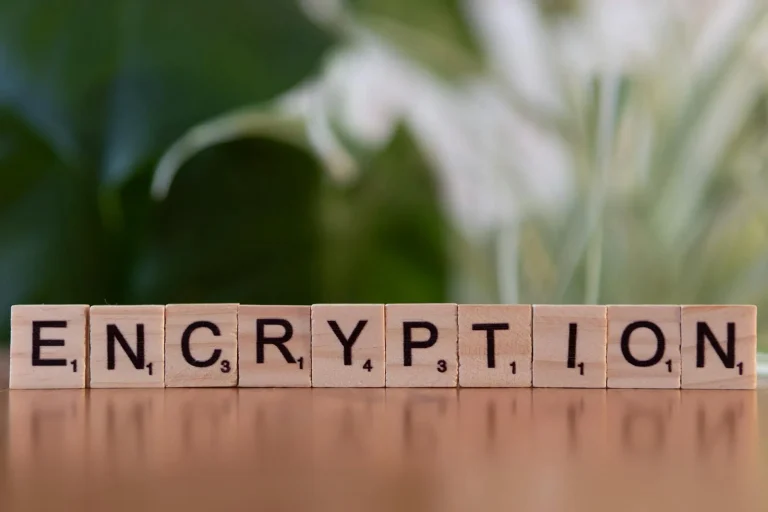 Wooden tiles spelling ENCRYPTION representing AI information security data protection