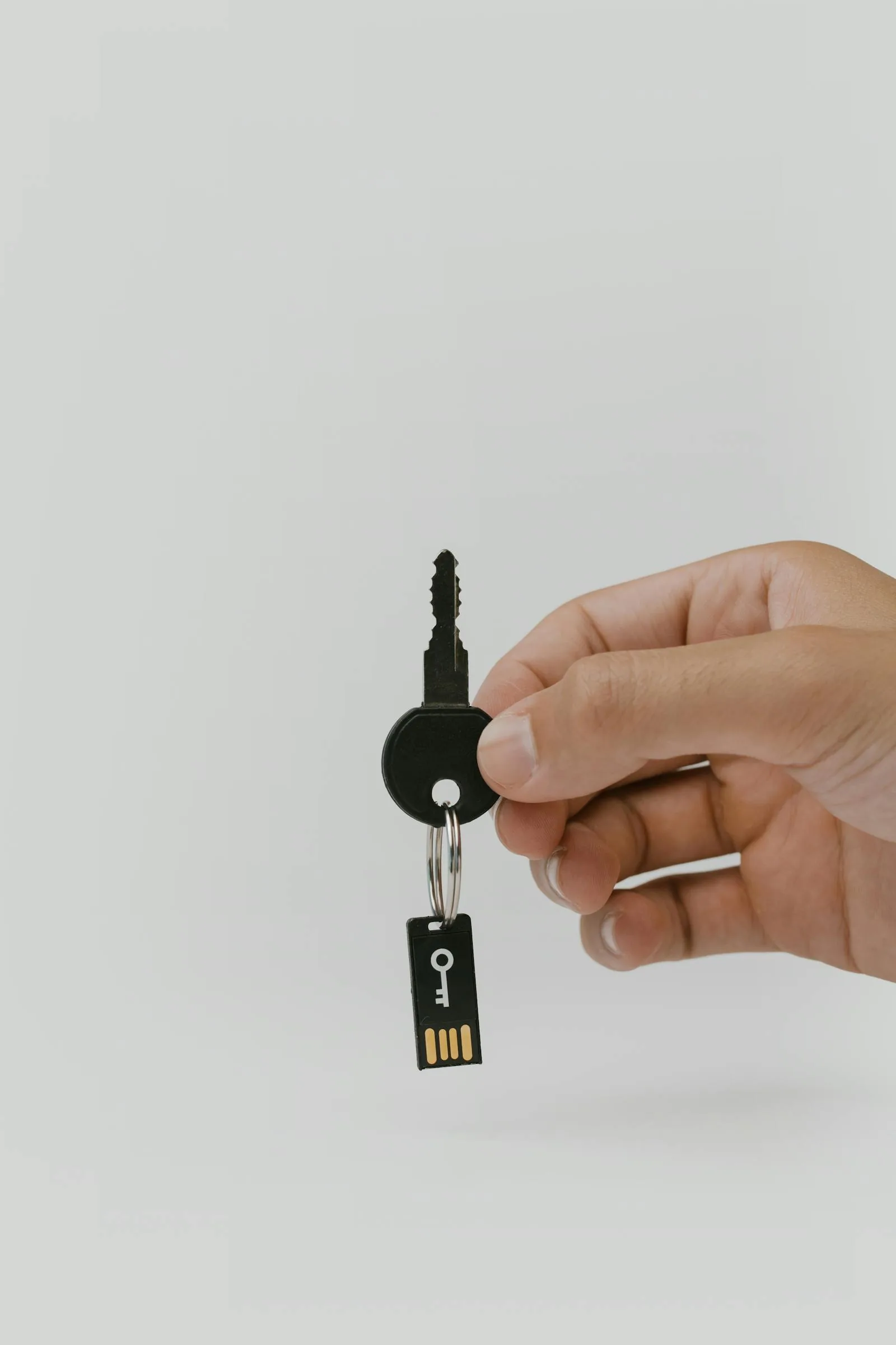 Physical key with USB security token representing UEBA insider threat detection