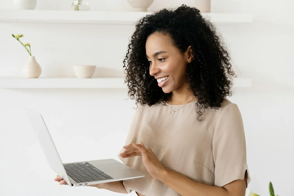 Cybersecurity analyst reviewing threat intelligence cycle on laptop in bright modern office representing intelligence cycle cyber security direction collection analysis phases