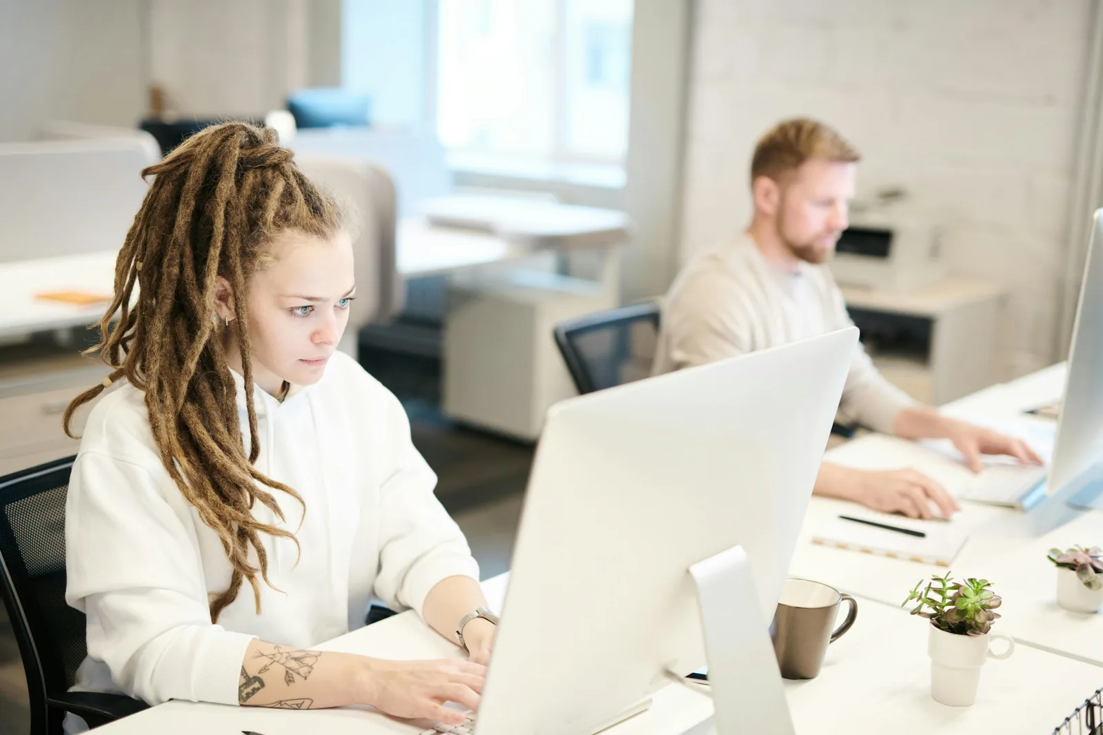 Security team working at computers in bright modern office representing intelligence cycle cyber security implementation STIX TAXII threat intelligence platforms MITRE ATT&CK