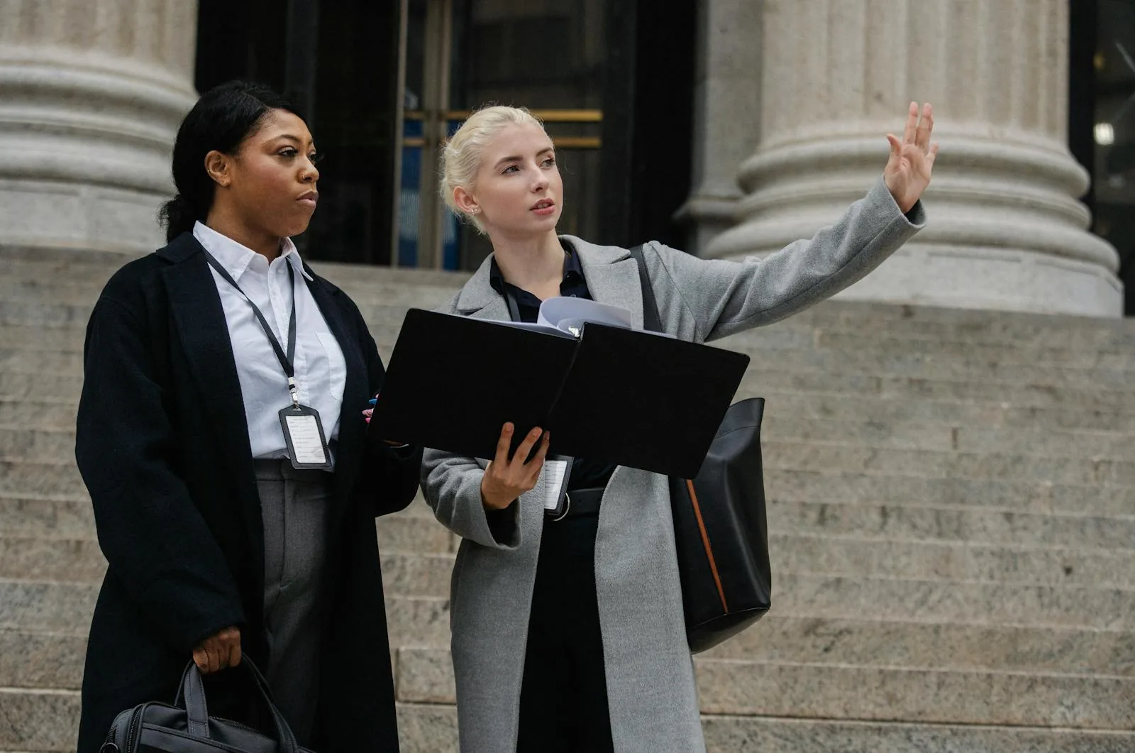 Professionals with identity badges outside government building representing career paths for KU national security intelligence graduates