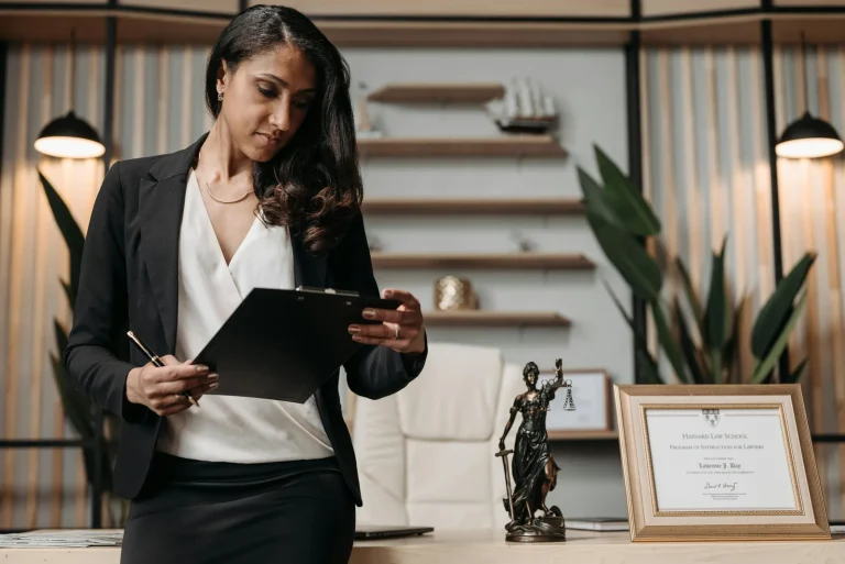 Legal professional reviewing AI cybersecurity regulation documents on laptop in bright modern office representing legality of artificial intelligence in cyber security EU AI Act regulation