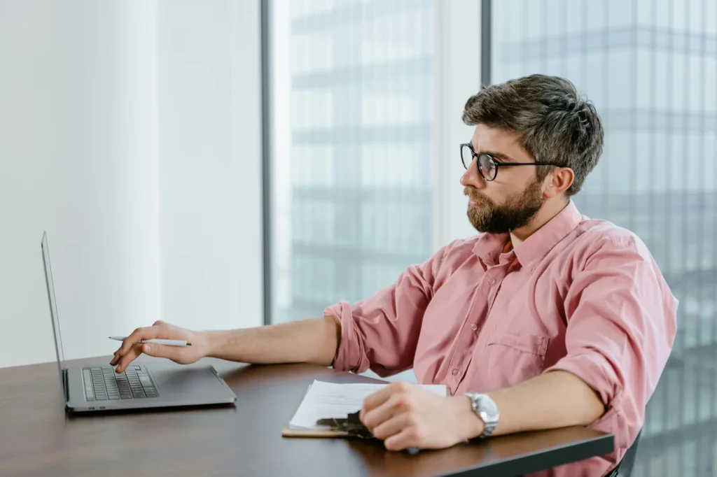 Security analyst working with Microsoft threat intelligence dashboard in bright modern operations center representing Microsoft security intelligence MSTIC MDDR 2025 scale