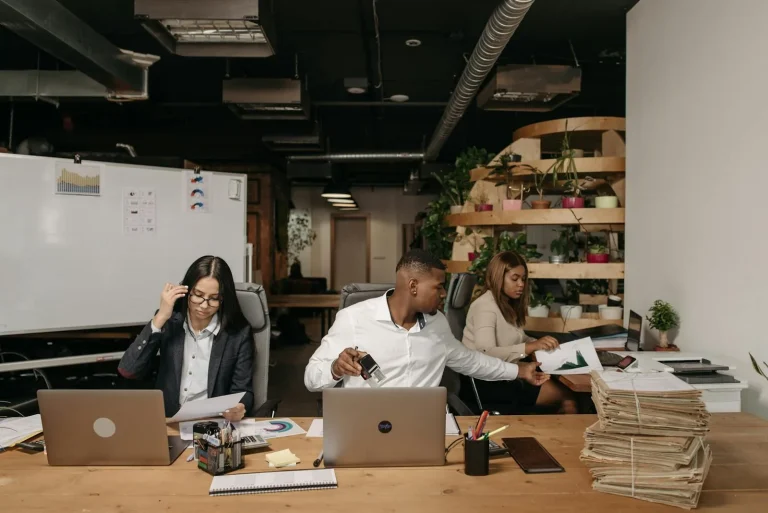 Network security professionals working on laptops in modern office representing network security intelligence NDR network detection response Darktrace Vectra AI behavioral analytics