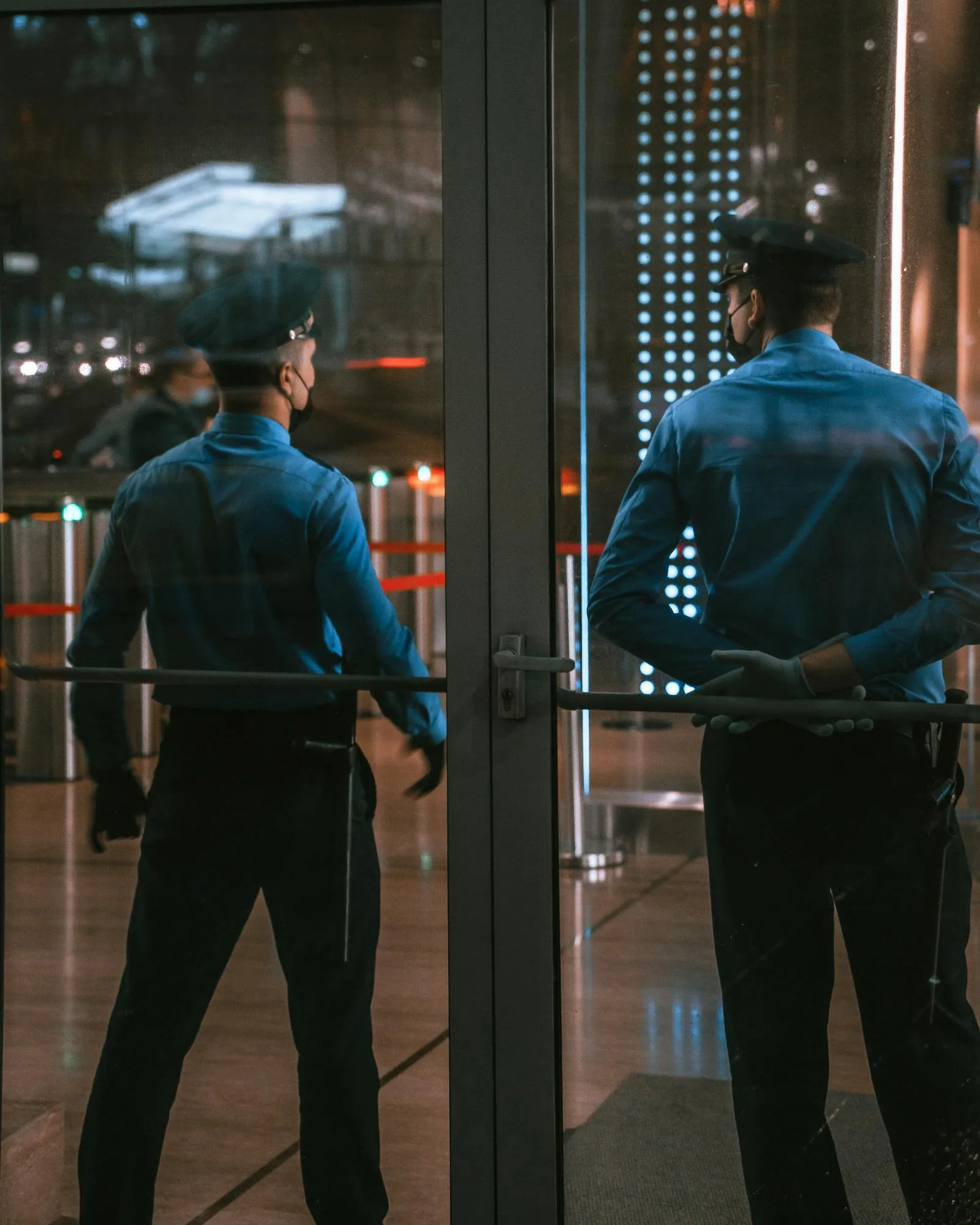 Security officers at building entrance managing physical access control as part of integrated GSOC operations