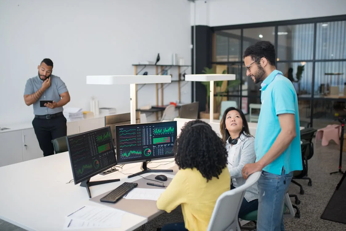 Security professional analyzing AI threat intelligence dashboard in bright modern office representing Robust Intelligence AI security Cisco platform architecture enterprise deployment