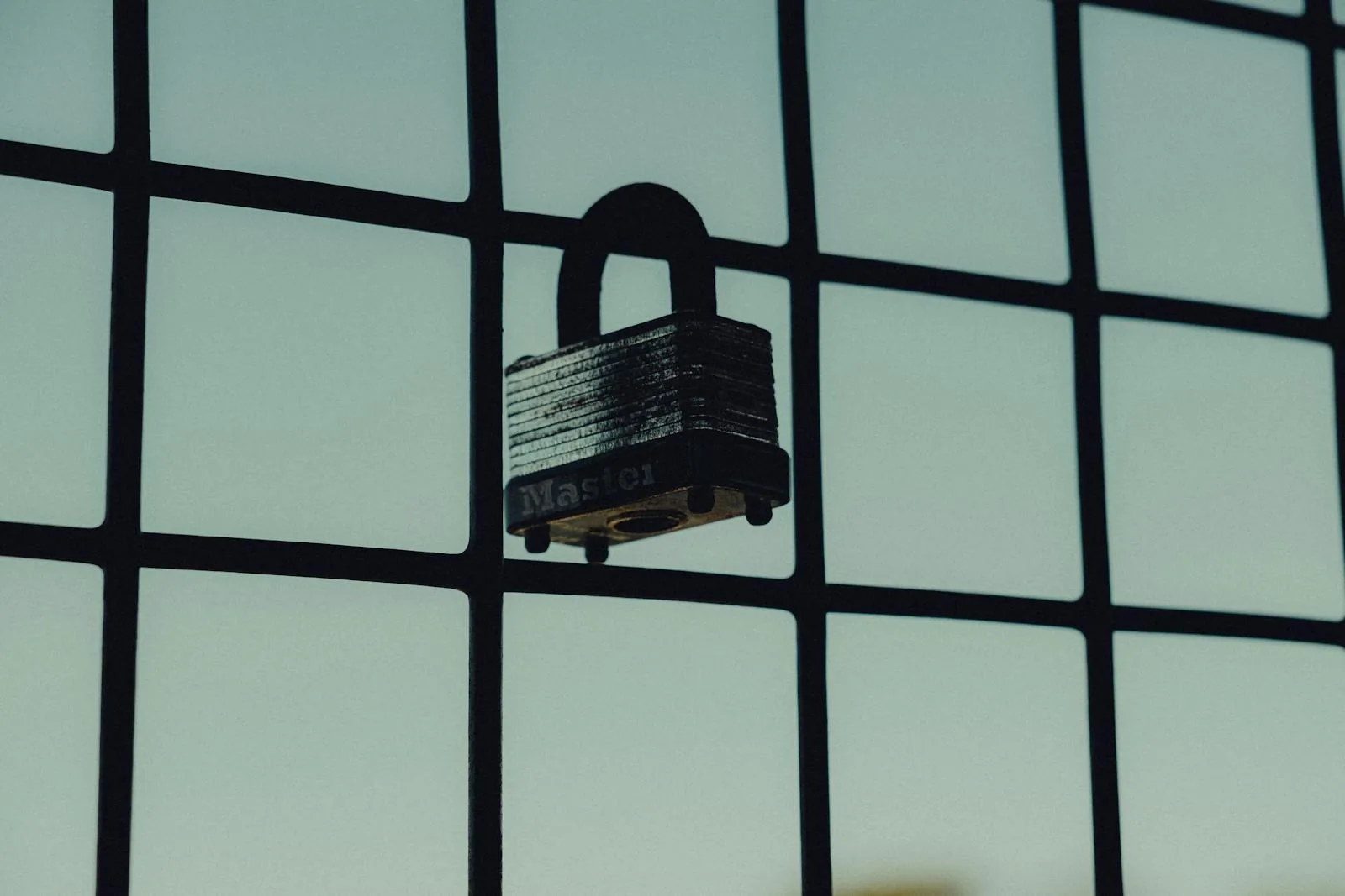 Steel padlock on fence representing the protection layer provided by Robust Intelligence AI Firewall and validation features