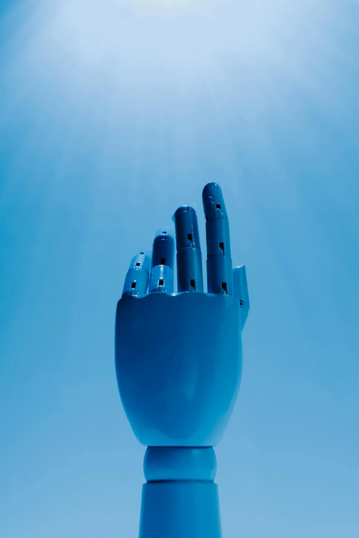 Blue robotic hand symbolizing the dual-use nature of artificial intelligence in cyber security