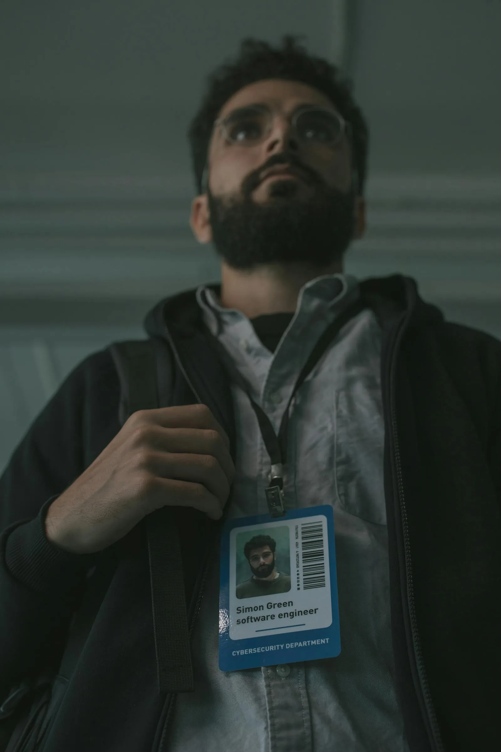 Software engineer with cybersecurity department ID badge representing AI-powered defense and security operations teams