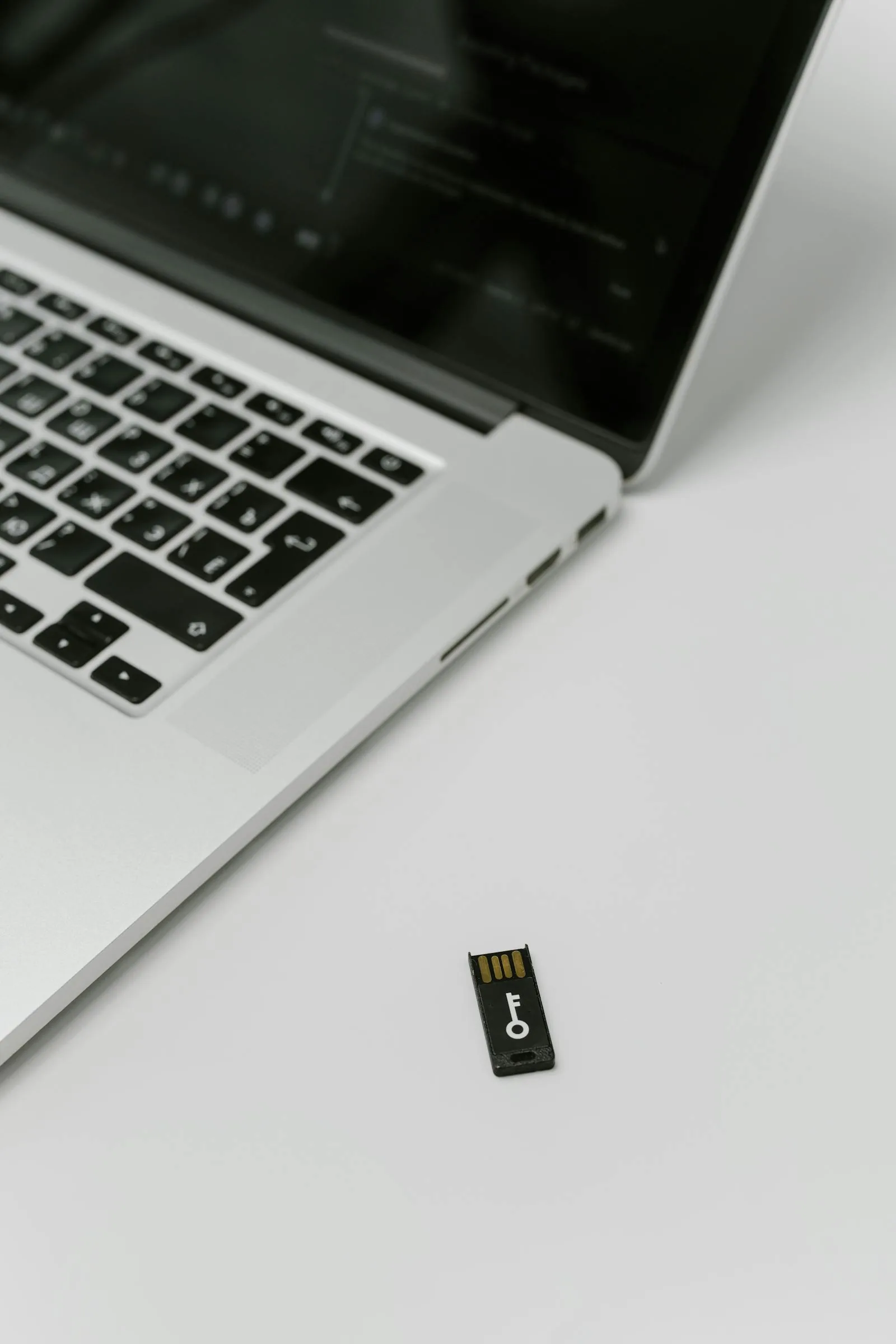 USB security key beside laptop representing AI security posture management and access controls for artificial intelligence systems