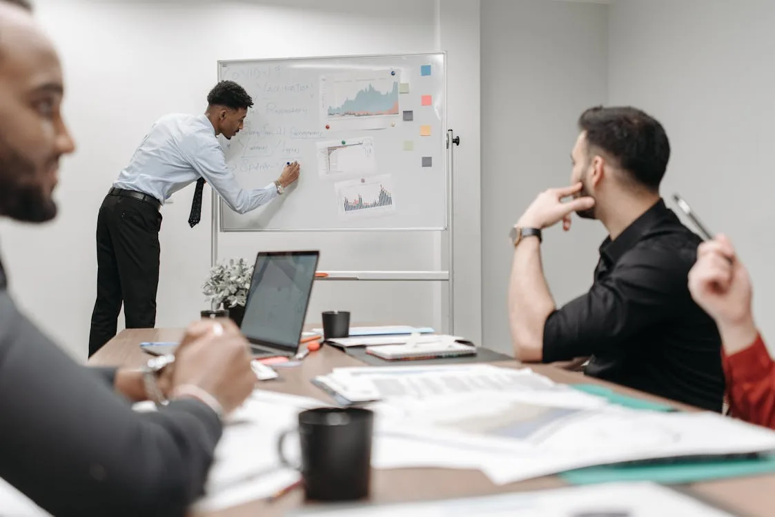 Professional security analyst with laptop and documents in bright modern workplace representing security intelligence analyst jobs salary certifications career progression