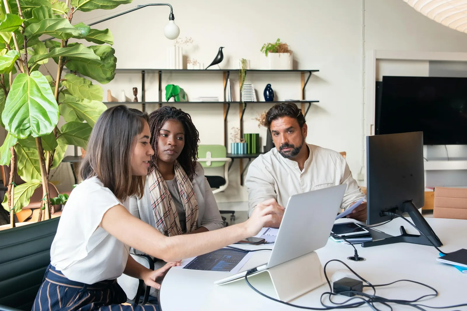 Enterprise security professionals using analytics platforms in bright modern security operations center representing security intelligence analytics platforms Splunk Sentinel CrowdStrike