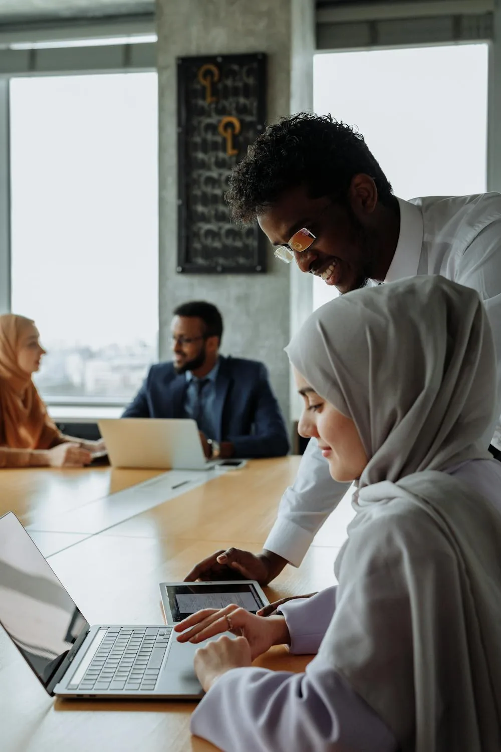 Security analysts conducting threat hunting using intelligence and analytics in bright modern security operations center representing threat hunting security intelligence and analytics
