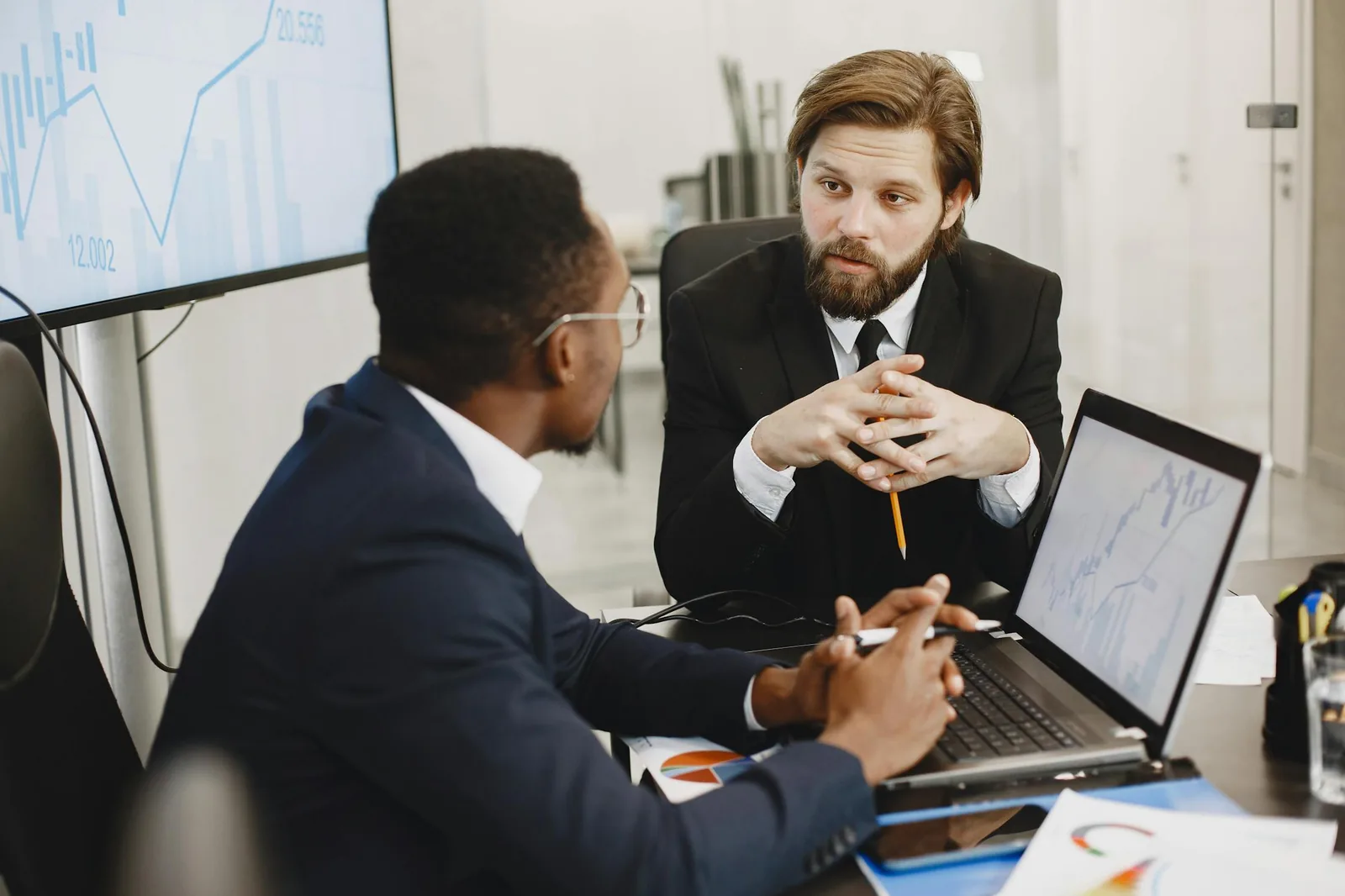 Security intelligence team analyzing threat data and analytics in bright modern operations center representing security intelligence and analytics integration threat detection