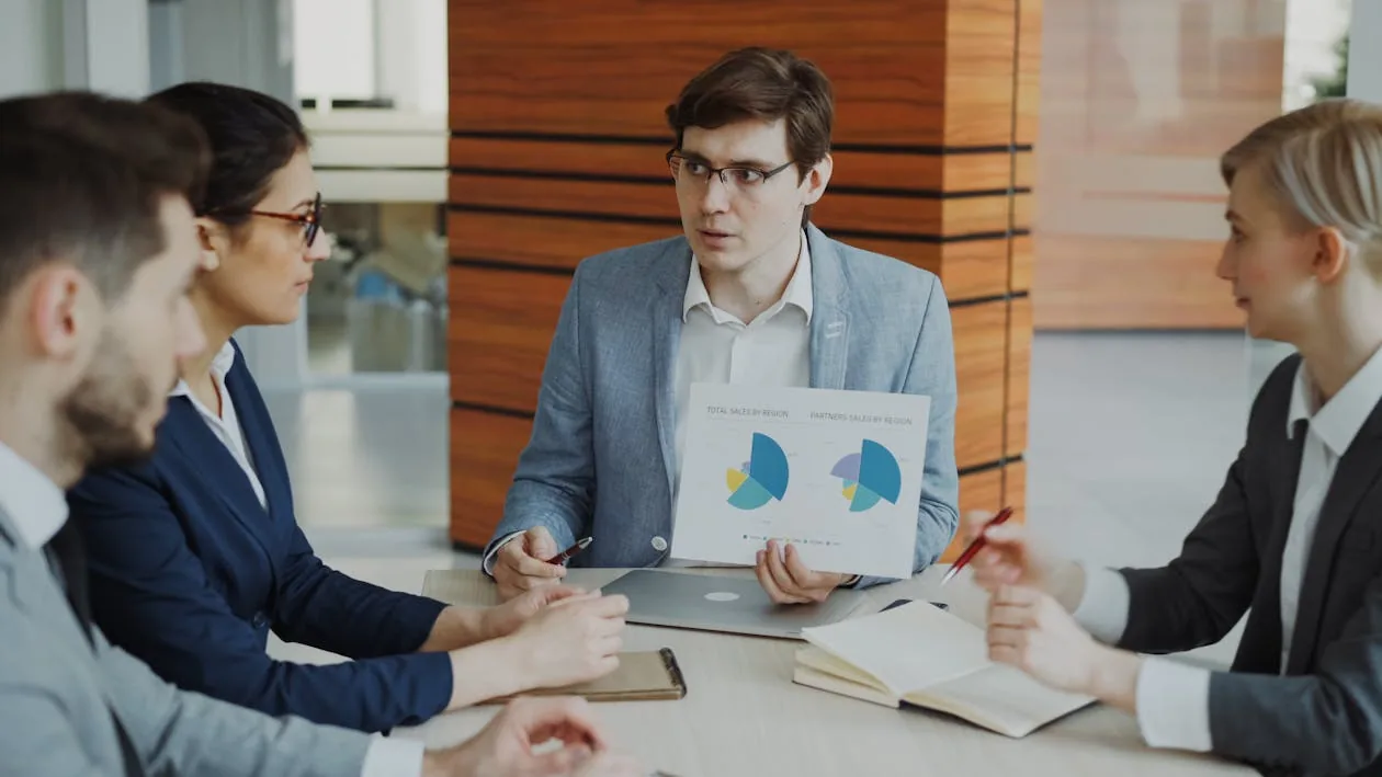 Security team reviewing intelligence reports and briefing boards in bright modern conference room representing security intelligence cycle operations PIRs F3EAD intelligence levels