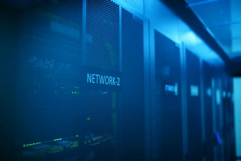 Server rack labeled NETWORK-2 in a modern data center with blue LED illumination representing security intelligence infrastructure