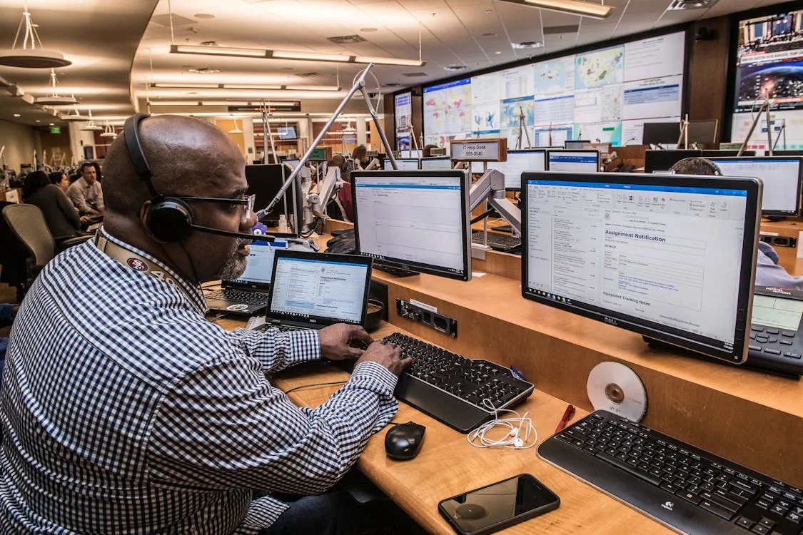 Security team integrating threat intelligence feeds into SIEM dashboard in bright modern security operations center representing security intelligence feeds integration workflow