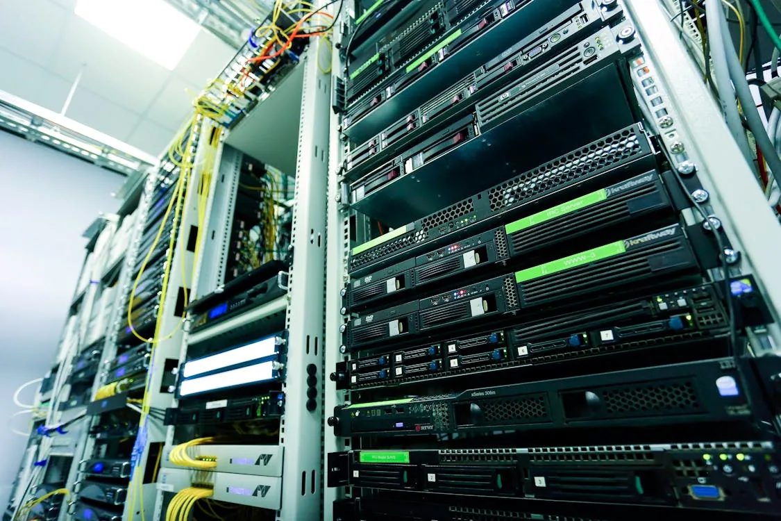 Enterprise server rack with multiple server units and fiber cables representing the infrastructure used for on-premises security intelligence platform deployment