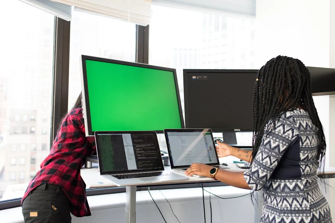 IT security team integrating threat intelligence updates into SIEM platform on laptop in bright modern office representing security intelligence update integration automation SIEM