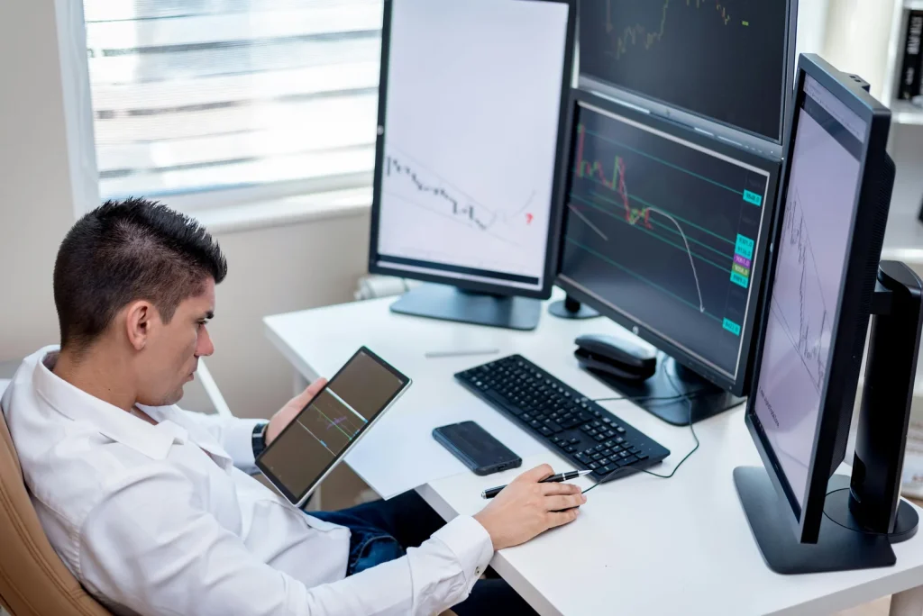 Security analyst reviewing multiple screens in bright modern security operations center representing security intelligence without analyst overhead alert fatigue problem