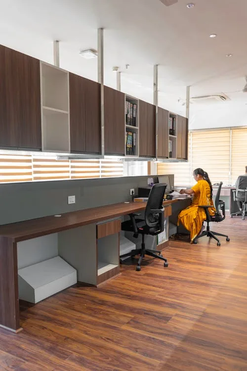 Security professional analyzing cloud-based threat monitoring dashboard in bright modern office representing security monitoring and intelligence systems deployment cloud hybrid AI