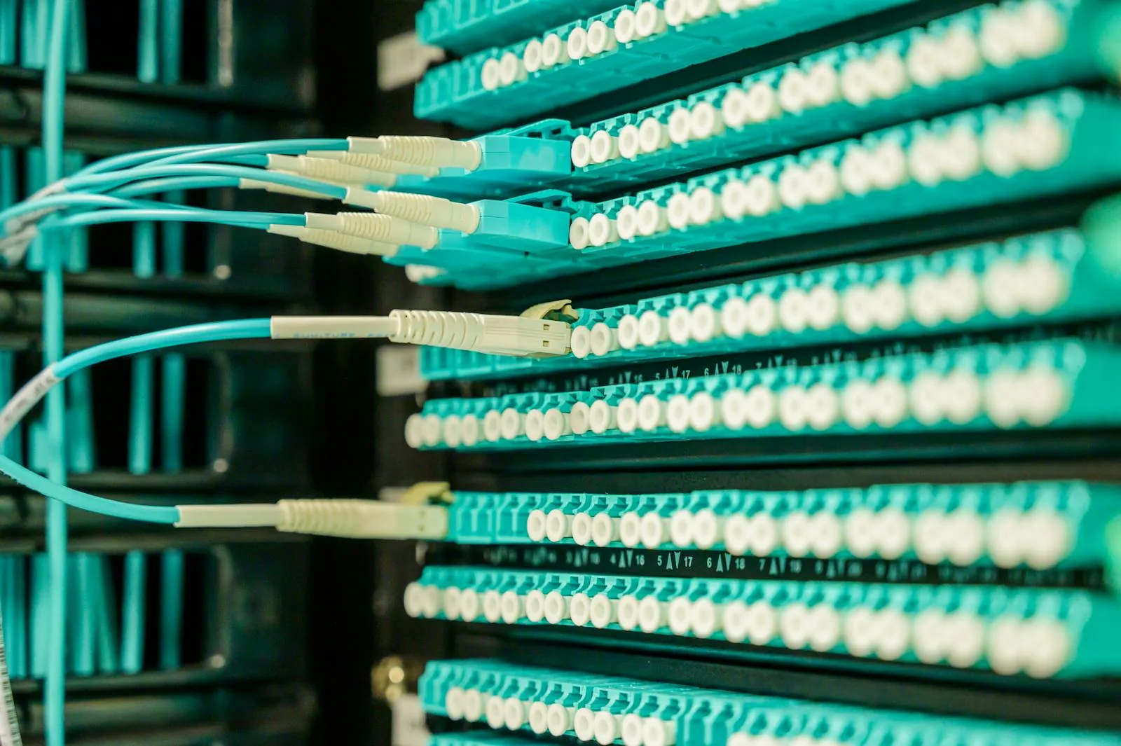 Patch panel fiber connections representing SIEM and firewall integration of security threat intelligence feeds