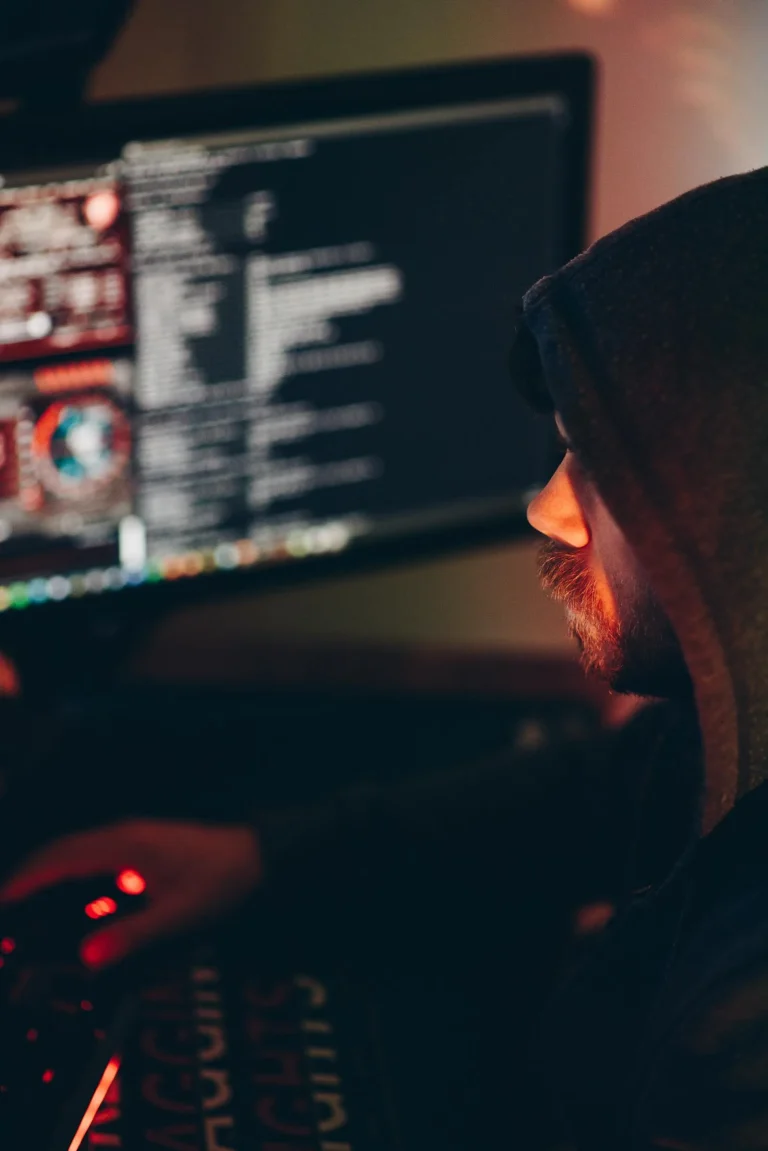 Cybersecurity analyst reviewing threat intelligence feed data on computer monitors